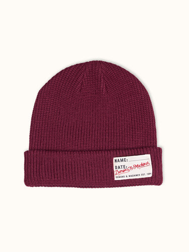 Gorro tejido Demons & Machines, estilo beanie, con textura de punto y ajuste cómodo para el invierno. #color_bordo