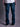 Jean de Demons & Machines de calce boot-cut confeccionado en denim elastizado. De tiro medio-alto, con entalle regular en cintura y cadera, y pierna que se va despegando terminando en una botamanga ligeramente abierta, ideal no solo para las botas sino para acompañar todo tipo de calzado.