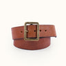 Cinturón modelo clásico confeccionado artesanalmente en cuero vacuno con terminación envejecida. Hebilla rectangular metálica grande en baño oro italiano y remaches baño cobre con refuerzo de cuero. Logo de marca grabado en bajo relieve. Forma parte de nuestra línea artesanal de accesorios de edición limitada, donde ningún producto es exactamente igual al otro. #color_marr-n