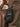 Guantes Redwood negros sostenidos junto a un bolso de cuero marrón, con protector de nudillos #color_negro