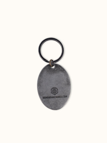 Llavero Sinclair de Demons & Machines, con diseño detallado y acabado metálico, ideal para llaves y accesorios.