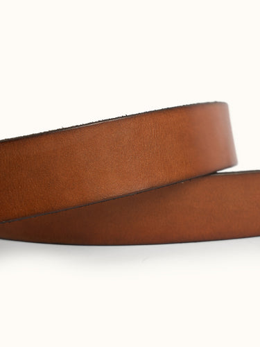 Warren Leather Belt detail — a durable metal buckle and an embossed logo. #color_tan