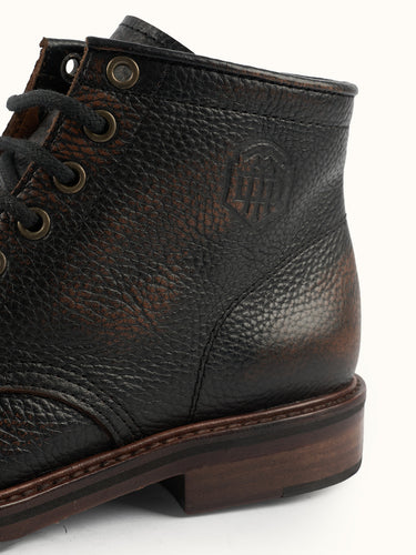 Botas Prison de la marca Demons & Machines, calzado negro con diseño robusto y detalles en la vista lateral.